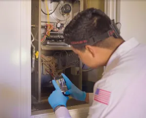 A technician repairing an air conditioner