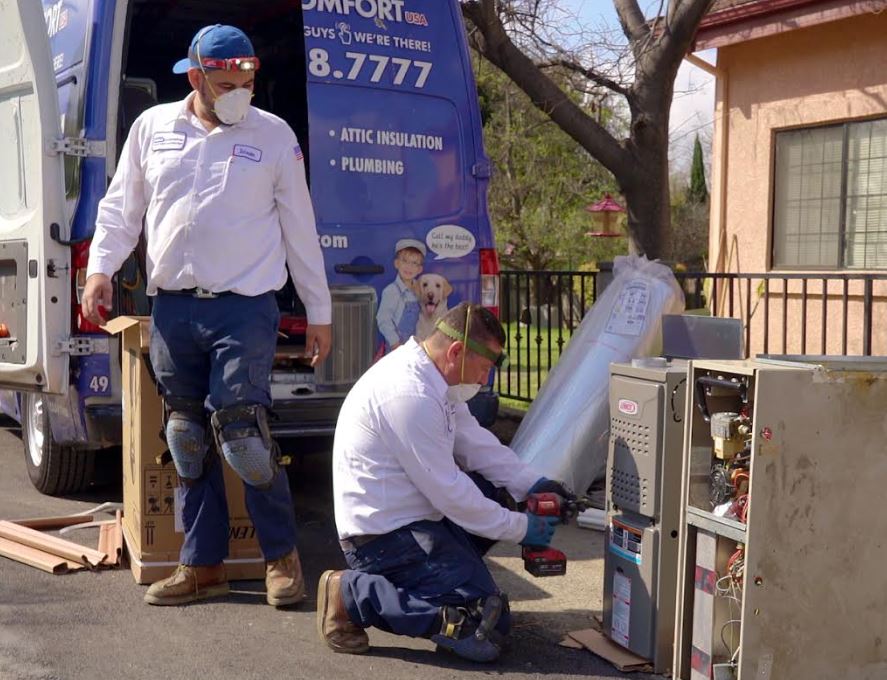 AC technicians installing a unit