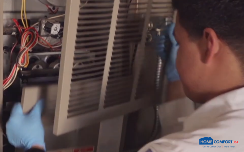 A technician working on an HVAC unit