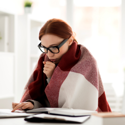 A woman covering up in a cold house