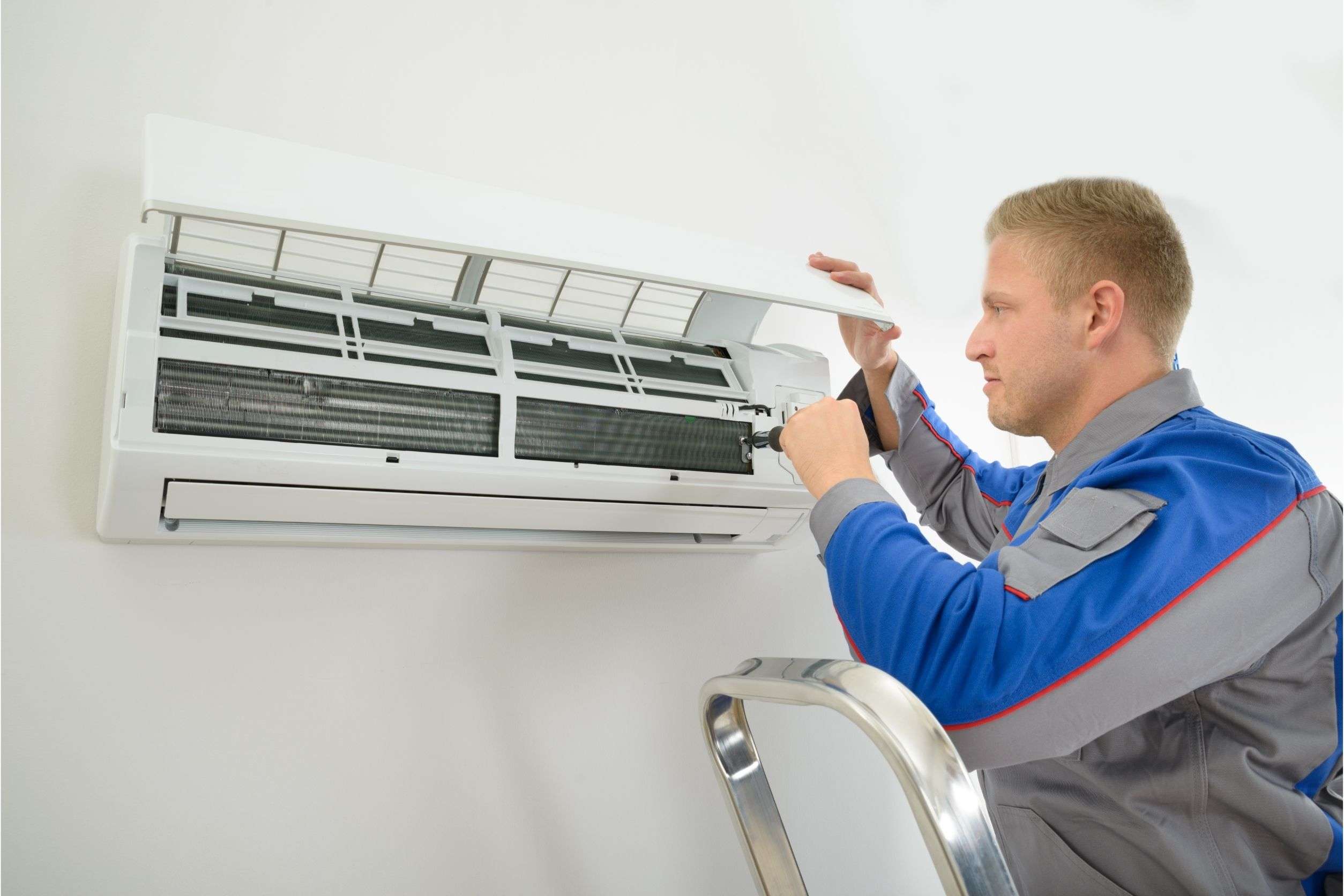 man fixing air conditioner mini split unit