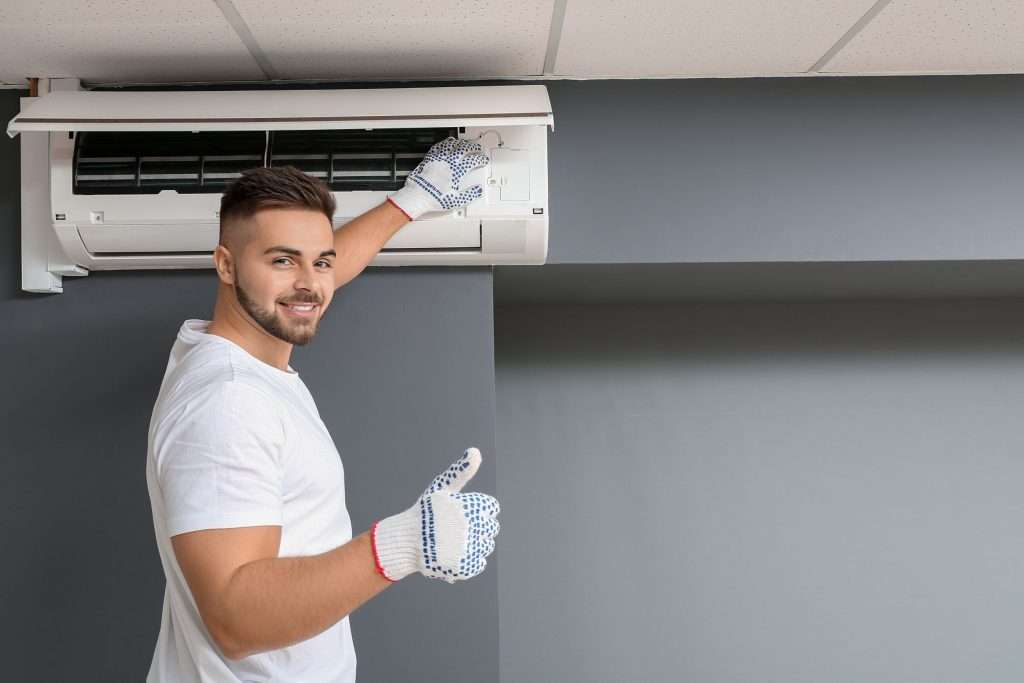 tech providing ac maintenance to extend ac lifespan