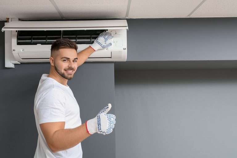 tech providing ac maintenance to extend ac lifespan