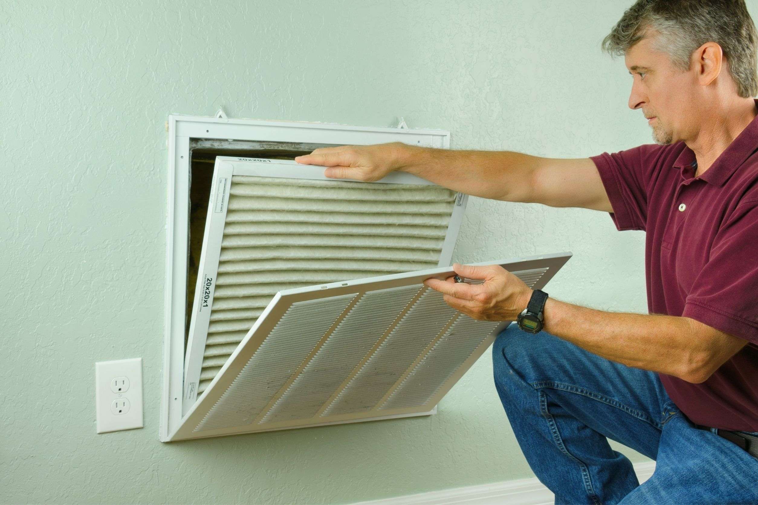 homeowner checking if it is time for HVAC maintenance