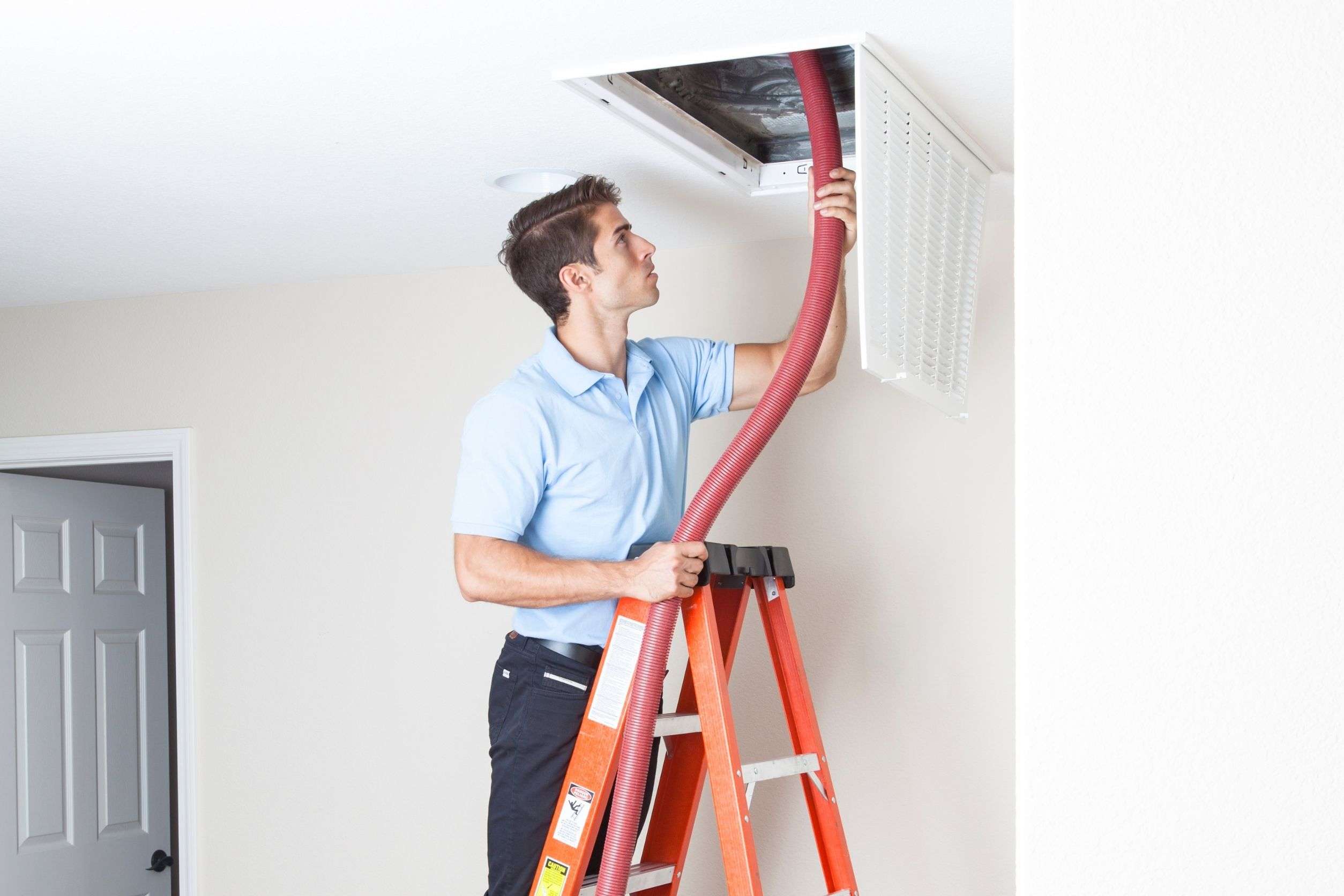 A tech is doing duct cleaning at a home