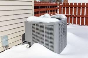 heater unit covered in snow that needs maintenance