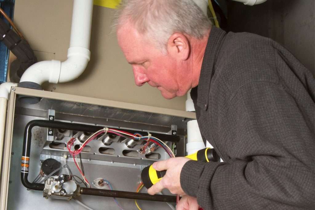 a tech checking if a furnace is effective