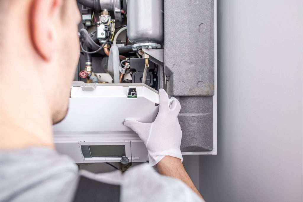 a tech repairing a furnace