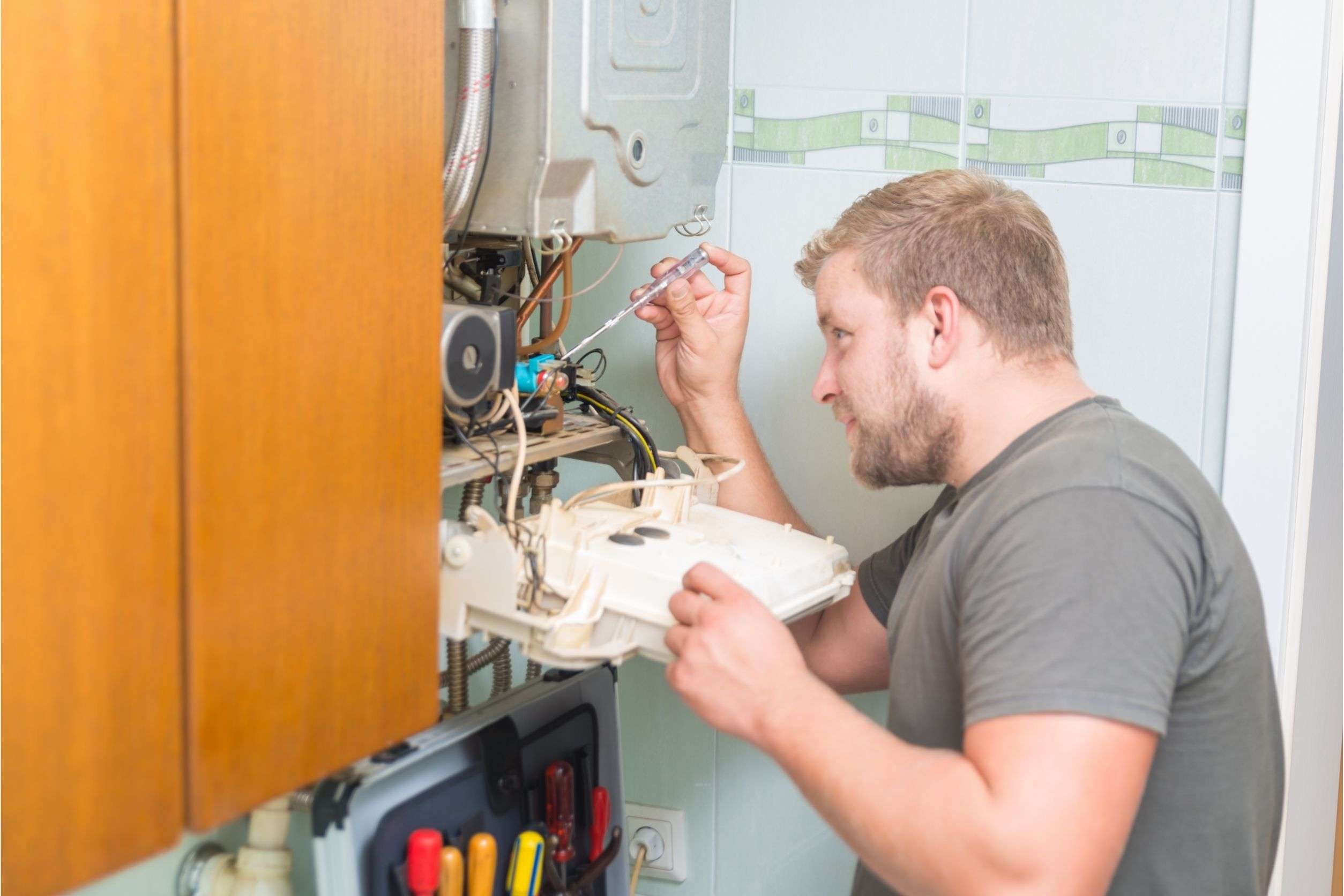 tech working on furnace repairs