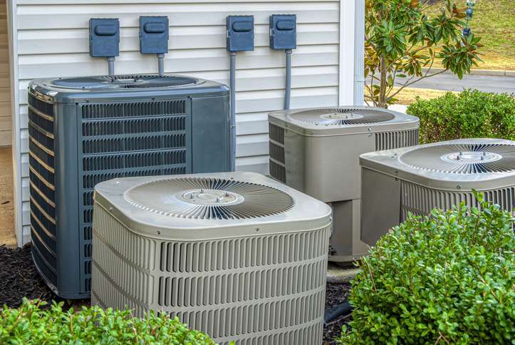 Shrubs surrounding outdoor ac condensers