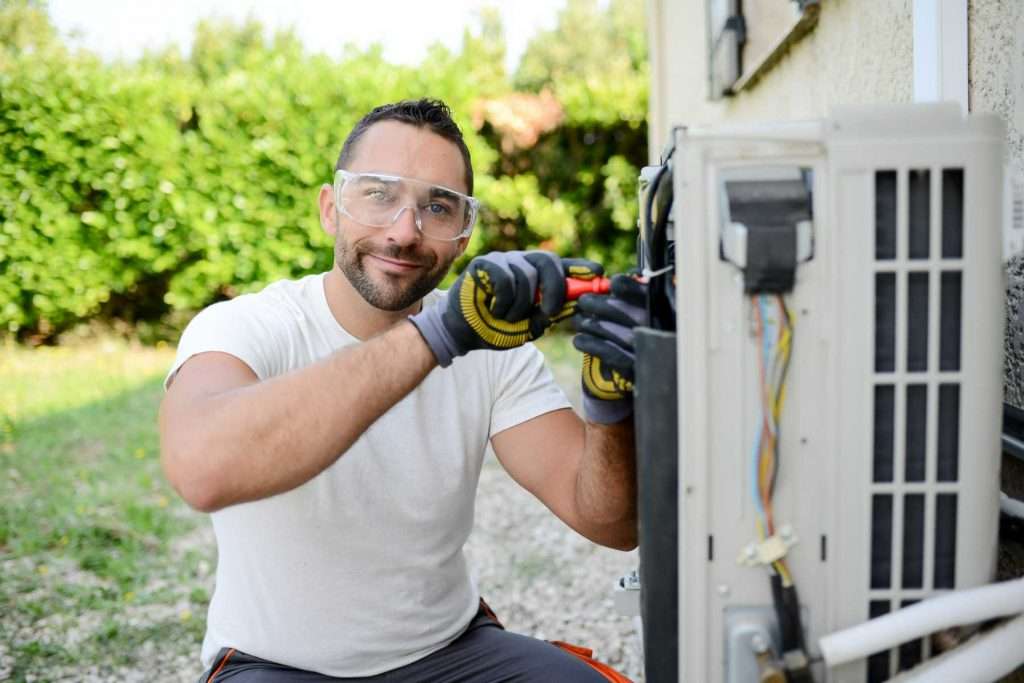 Homeowner working on an outsider air conditioner unit