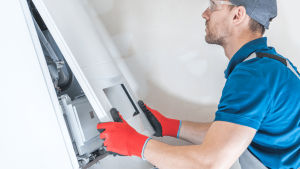 image of an HVAC tech working on a furnace