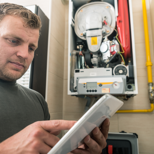 HVAC technician inspecting a furnace rattling