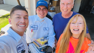 HVAC installation team and homeowners